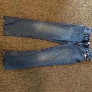 They sat straight blue Jeans